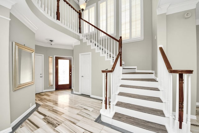 12819 Kingsbridge Ln, Houston, TX 77077 - entryway with crown molding, plenty of natural light, baseboards, stairway, and a towering ceiling