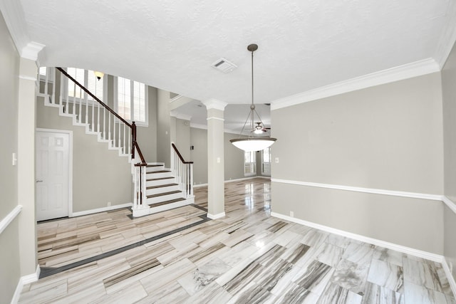 12819 Kingsbridge Ln, Houston, TX 77077 - unfurnished living room with decorative columns, stairs, baseboards, and ornamental molding