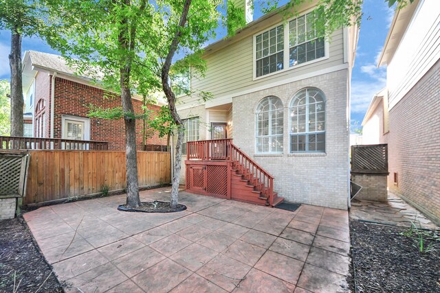 12819 Kingsbridge Ln, Houston, TX 77077 - back of property featuring brick siding and a patio
