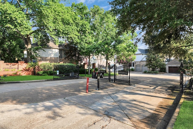 12819 Kingsbridge Ln, Houston, TX 77077 - view of concrete road with a gate, curbs, and a gated entry
