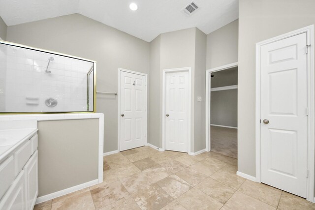 12819 Kingsbridge Ln, Houston, TX 77077 - full bath featuring tiled shower, lofted ceiling, vanity, baseboards, and recessed lighting
