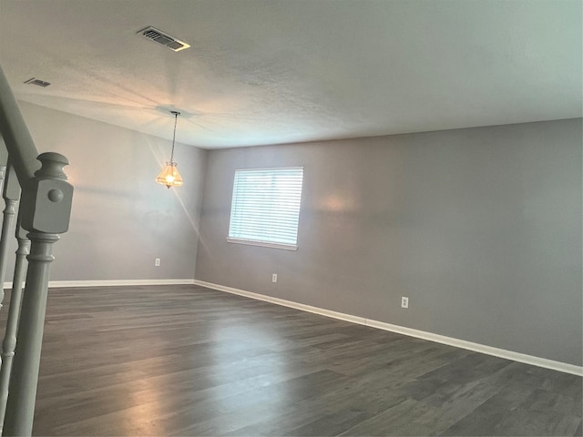 16219 Purpleridge Ct, Houston, TX 77053 - empty room featuring baseboards, dark wood-style flooring, and a textured ceiling