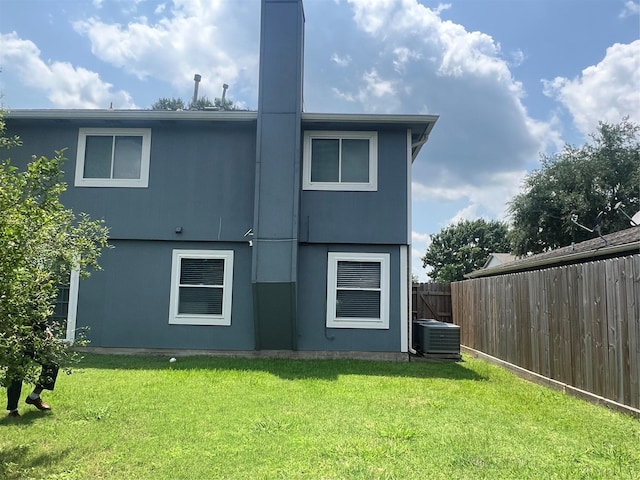 16219 Purpleridge Ct, Houston, TX 77053 - back of property with central air condition unit and a chimney