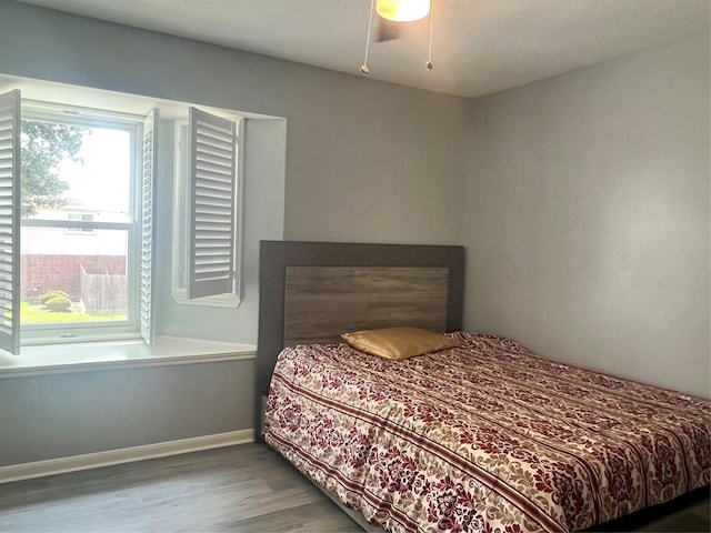 16219 Purpleridge Ct, Houston, TX 77053 - bedroom with wood finished floors, baseboards, and ceiling fan