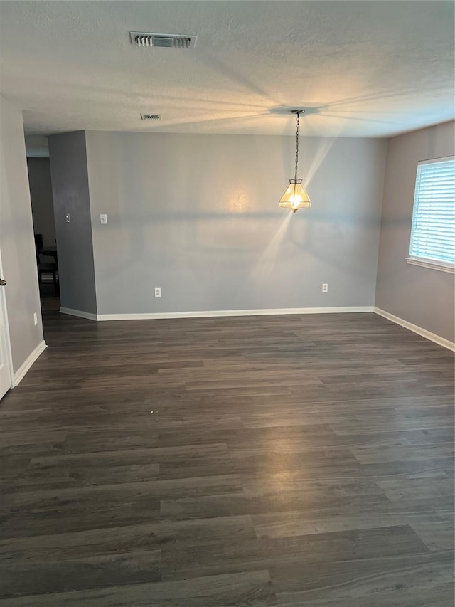 16219 Purpleridge Ct, Houston, TX 77053 - spare room featuring baseboards, dark wood-style floors, and a textured ceiling