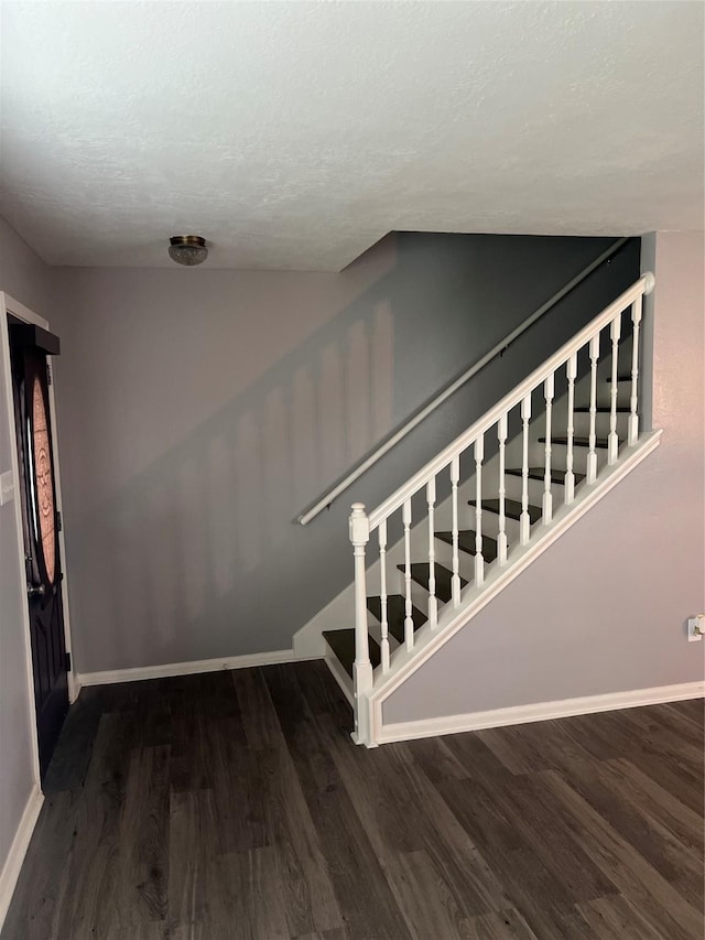 16219 Purpleridge Ct, Houston, TX 77053 - stairway featuring wood finished floors, baseboards, and a textured ceiling