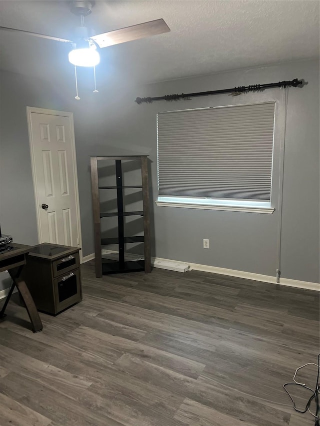 16219 Purpleridge Ct, Houston, TX 77053 - unfurnished bedroom with wood finished floors, baseboards, and a ceiling fan