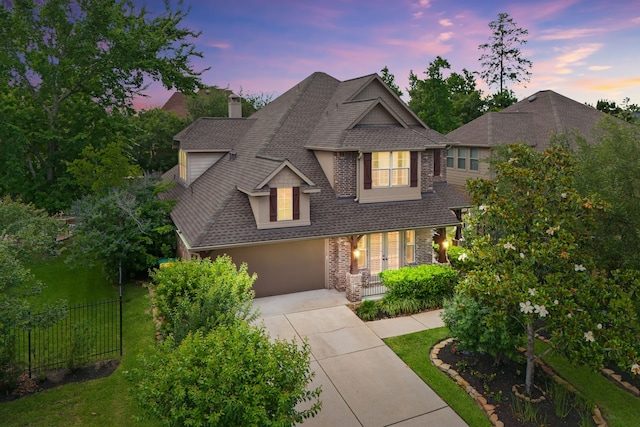 6 Red Wagon Dr, The Woodlands, TX 77389 - view of front of home featuring a shingled roof, driveway, covered porch, a chimney, and an attached garage