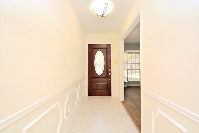 839 Hidden Canyon Rd, Katy, TX 77450 - entryway featuring light tile patterned floors, wainscoting, and a decorative wall