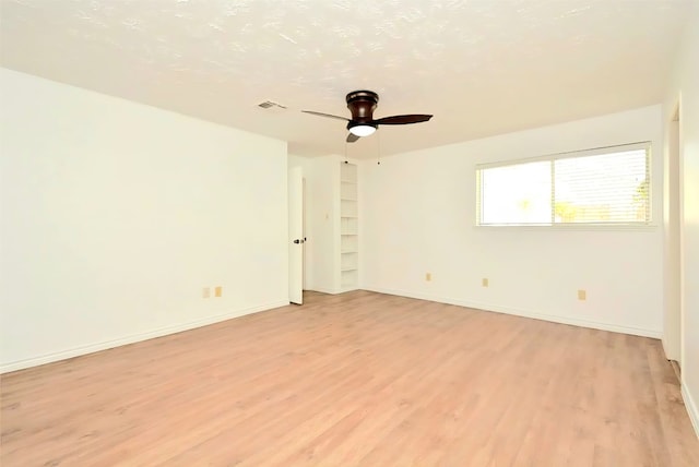 839 Hidden Canyon Rd, Katy, TX 77450 - empty room featuring light wood-type flooring, ceiling fan, and baseboards
