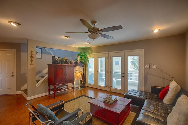 907 Davis Rd, League City, TX 77573 - living room with wood finished floors, ceiling fan, stairway, and baseboards