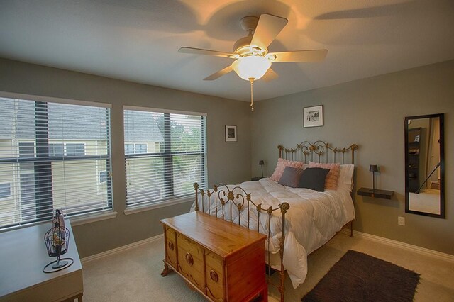 907 Davis Rd, League City, TX 77573 - bedroom featuring light carpet, baseboards, and a ceiling fan