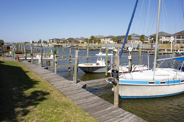 907 Davis Rd, League City, TX 77573 - dock featuring boat lift, a water view, and a residential view