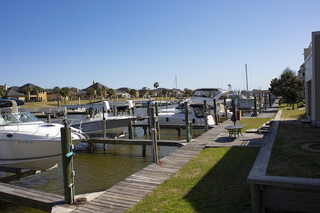 907 Davis Rd, League City, TX 77573 - dock with boat lift, a water view, a yard, and a residential view