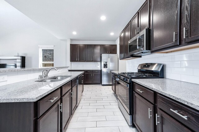 32322 Dusted Bronze Dr, Brookshire, TX 77423 - kitchen featuring stainless steel appliances, a sink, decorative backsplash, recessed lighting, and dark brown cabinetry