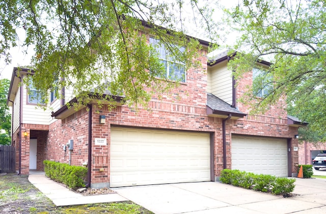 5227 Brinkman Ct, Houston, TX 77091 - view of front of house featuring a garage, brick siding, and concrete driveway