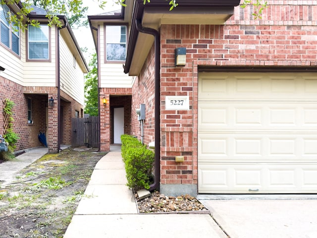 5227 Brinkman Ct, Houston, TX 77091 - property entrance with a garage and brick siding