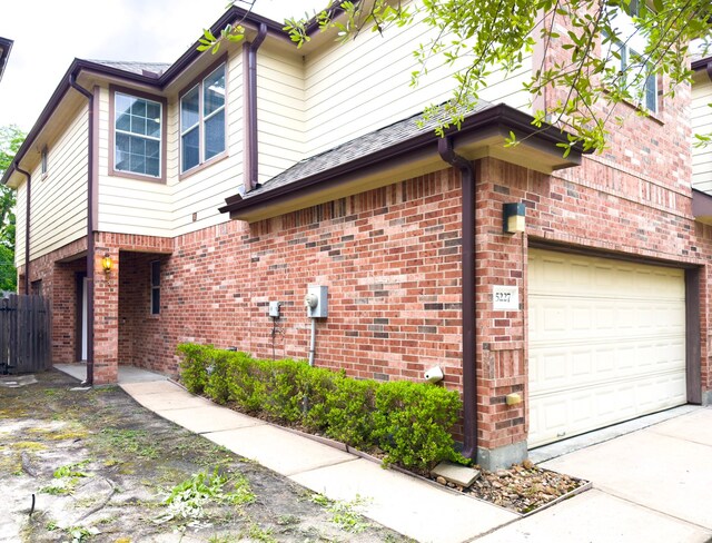5227 Brinkman Ct, Houston, TX 77091 - view of side of property featuring brick siding and driveway