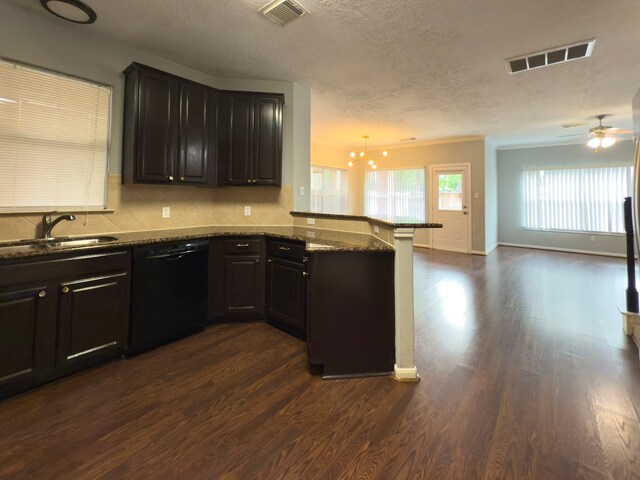 5227 Brinkman Ct, Houston, TX 77091 - kitchen with black dishwasher, a sink, a peninsula, dark wood-style floors, and open floor plan