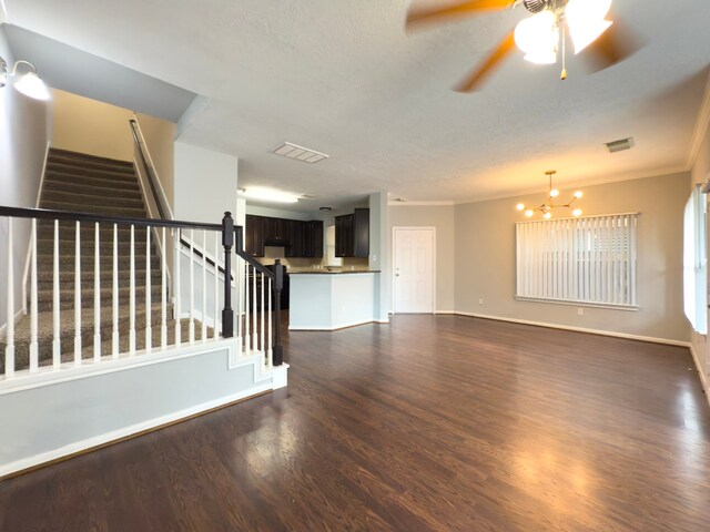 5227 Brinkman Ct, Houston, TX 77091 - unfurnished living room featuring dark wood finished floors, crown molding, stairway, a chandelier, and ceiling fan