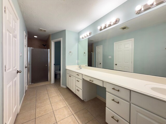 5227 Brinkman Ct, Houston, TX 77091 - bathroom with double vanity, a shower stall, tile patterned floors, toilet, and baseboards