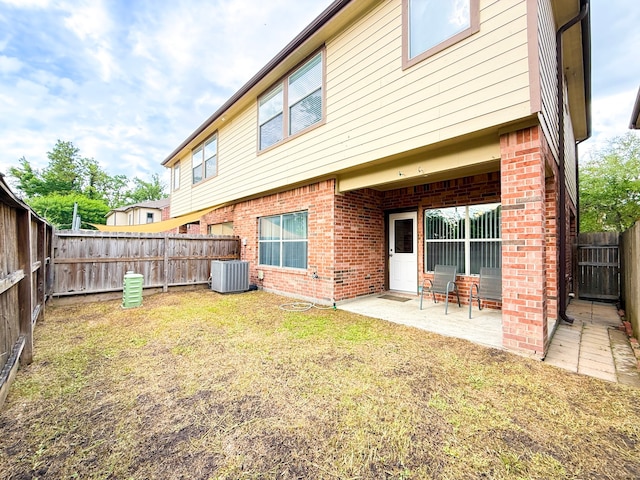 5227 Brinkman Ct, Houston, TX 77091 - rear view of property with central air condition unit, a patio area, and brick siding