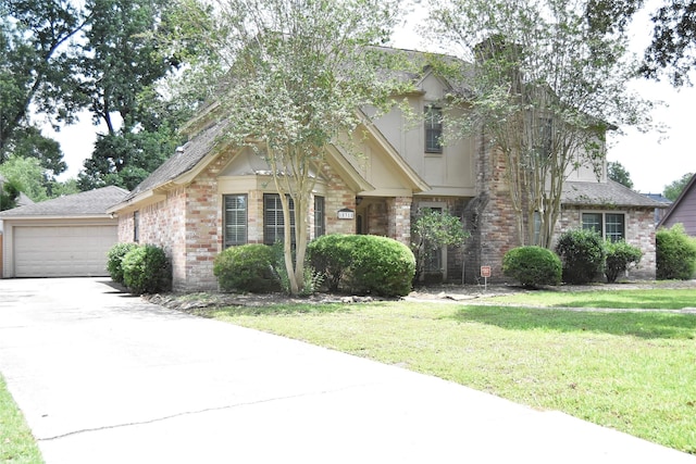 18318 Ella Blvd, Spring, TX 77388 - view of front of home with a garage, a front yard, brick siding, driveway, and stone siding
