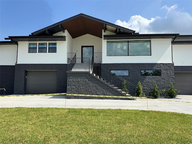 5115 S Braeswood Blvd, Houston, TX 77096 - view of front of house with concrete driveway, an attached garage, stucco siding, and a front lawn