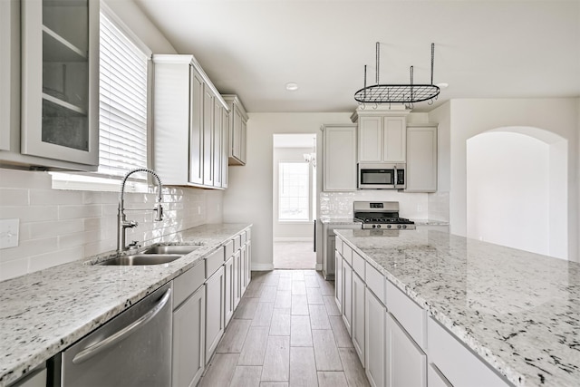 350 Selah Ct, Alvin, TX 77511 - kitchen featuring appliances with stainless steel finishes, light stone countertops, and backsplash