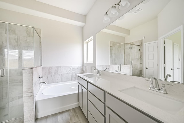 350 Selah Ct, Alvin, TX 77511 - full bathroom featuring a bath, a stall shower, double vanity, wood finished floors, and tile walls