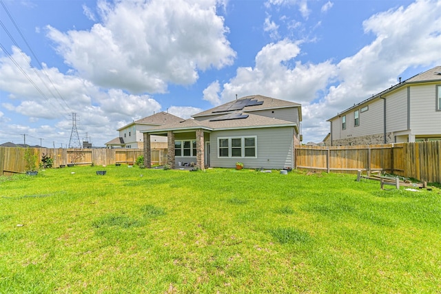 350 Selah Ct, Alvin, TX 77511 - back of house with roof mounted solar panels and a fenced backyard