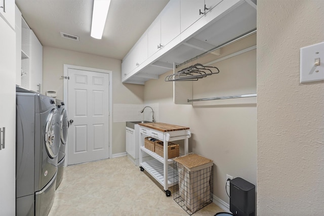 15 River Ridge Loop, The Woodlands, TX 77389 - laundry room featuring washing machine and clothes dryer and cabinet space