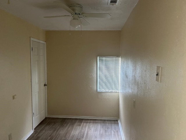 6322 Purple Sage Rd, Houston, TX 77049 - unfurnished room with wood finished floors, ceiling fan, and baseboards