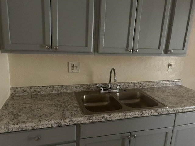 6322 Purple Sage Rd, Houston, TX 77049 - kitchen featuring a sink and gray cabinetry