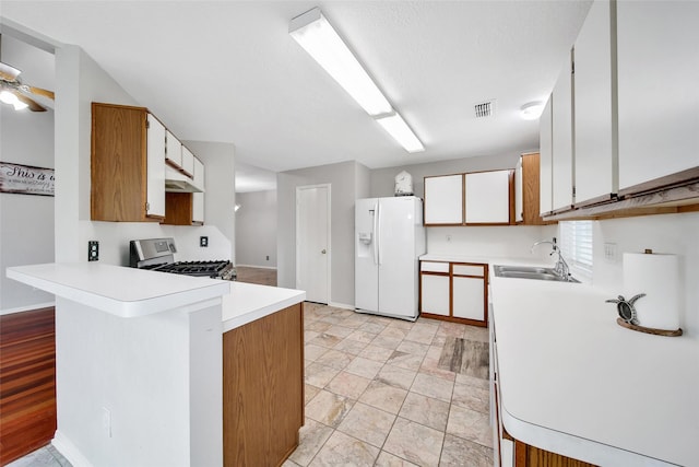 1726 Havelock Dr, Spring, TX 77386 - kitchen with white fridge with ice dispenser, a sink, stainless steel range, a peninsula, and light countertops