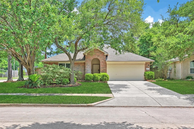 1726 Havelock Dr, Spring, TX 77386 - view of front of property featuring a garage, driveway, brick siding, and roof with shingles
