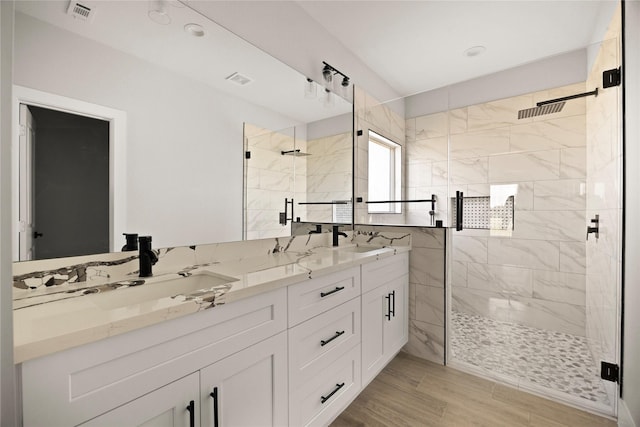 42 Meadow Lake Dr, Trinity, TX 75862 - full bathroom featuring a stall shower, double vanity, and wood finished floors