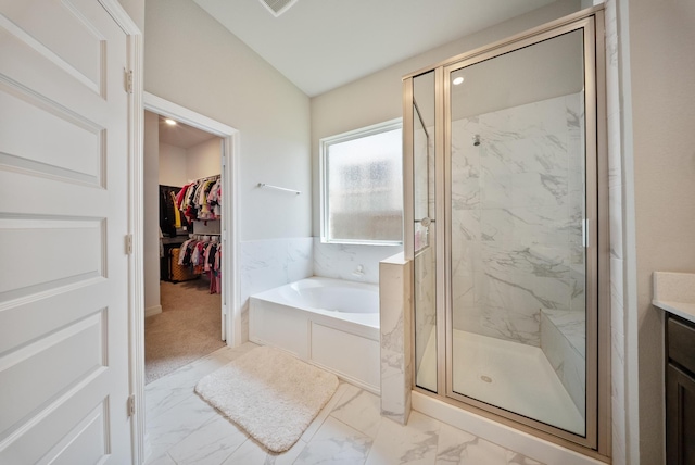29023 Laurel Grove Ln, Fulshear, TX 77441 - full bathroom featuring a garden tub, marble look tiles, a marble finish shower, a spacious closet, and vanity