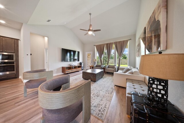 29023 Laurel Grove Ln, Fulshear, TX 77441 - living area with light wood-style floors, a ceiling fan, and high vaulted ceiling
