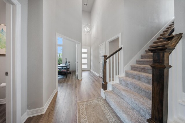 29023 Laurel Grove Ln, Fulshear, TX 77441 - foyer with stairs, wood finished floors, a towering ceiling, and baseboards