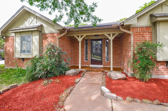 11703 Easterling Dr, Houston, TX 77065 - doorway to property featuring brick siding, a porch, and roof with shingles