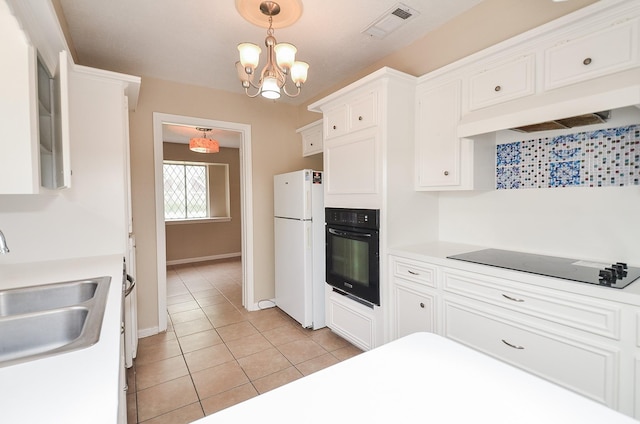 11703 Easterling Dr, Houston, TX 77065 - kitchen featuring black appliances, a sink, light tile patterned floors, and white cabinets