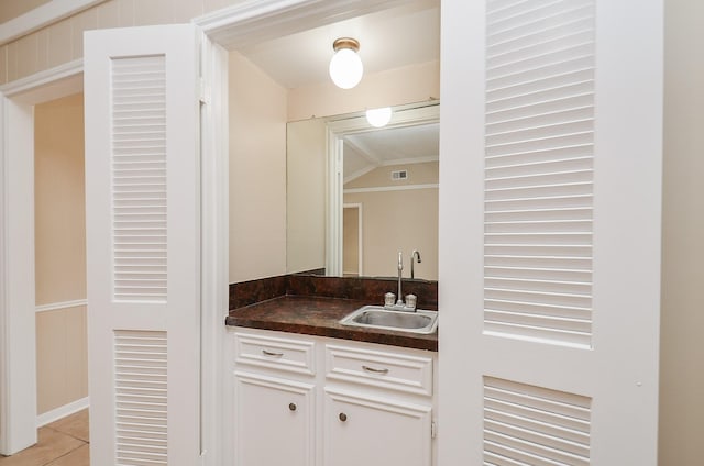 11703 Easterling Dr, Houston, TX 77065 - bar featuring a sink, light tile patterned floors, and vaulted ceiling
