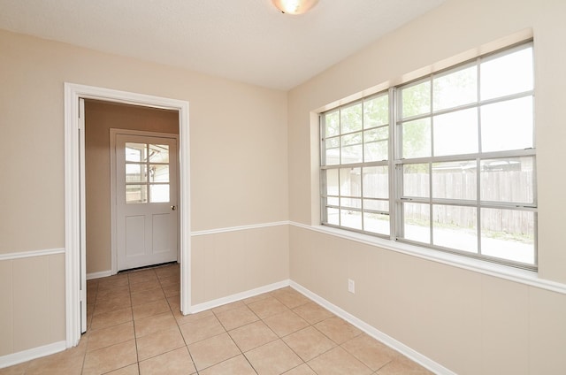 11703 Easterling Dr, Houston, TX 77065 - spare room with healthy amount of natural light, light tile patterned flooring, and baseboards