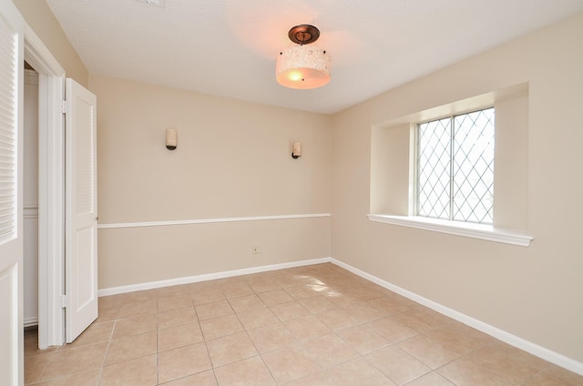 11703 Easterling Dr, Houston, TX 77065 - spare room featuring light tile patterned floors and baseboards