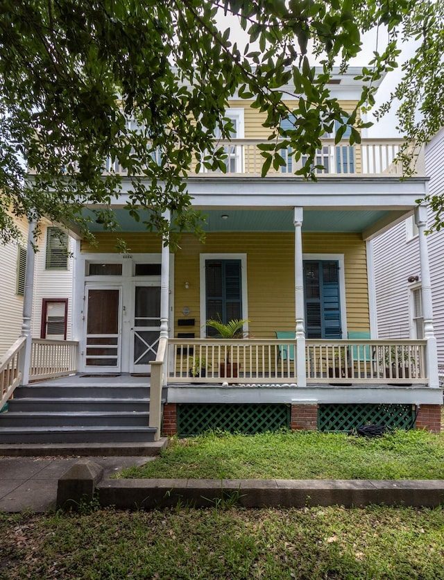 1124 Winnie St, Galveston, TX 77550 - view of front facade featuring covered porch and a balcony