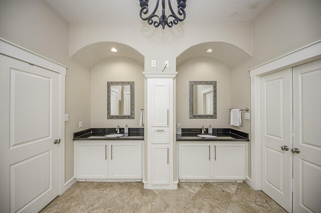 1239 W 22nd St Unit C, Houston, TX 77008 - full bath featuring a chandelier, two vanities, and baseboards