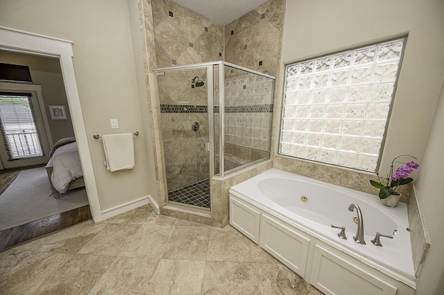 1239 W 22nd St Unit C, Houston, TX 77008 - ensuite bathroom with a whirlpool tub, a shower stall, and baseboards