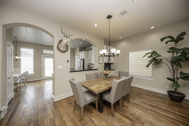 1239 W 22nd St Unit C, Houston, TX 77008 - dining room with a chandelier, arched walkways, dark wood-style floors, baseboards, and recessed lighting