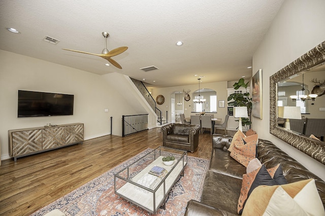 1239 W 22nd St Unit C, Houston, TX 77008 - living area featuring a chandelier, wood finished floors, arched walkways, a ceiling fan, and a textured ceiling